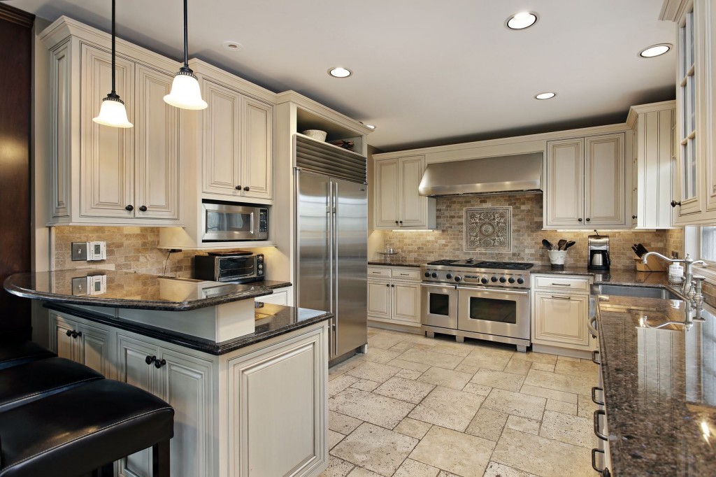 A kitchen with granite counter tops and stainless steel appliances.